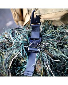 Tactical Attachment Strap in use photo, clipping a ghillie suit to a bag.